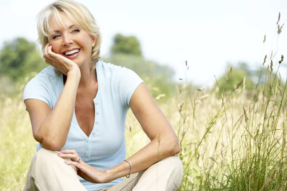 Portrait of mature woman sitting in countryside